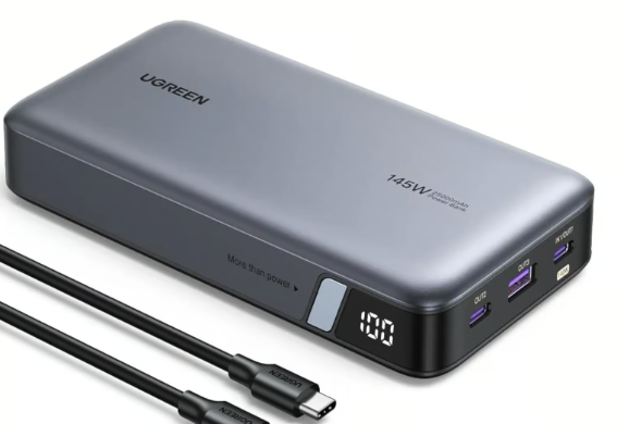 A rectangular portable battery with three ports, displaying the text 100 to indicate the level of remaining charge. Two USB C cables are to the left