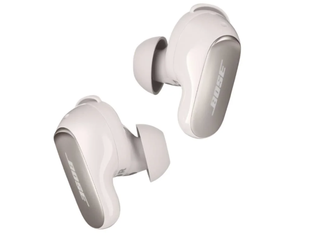 Two cream in-ear headphones with soft plastic inners and wing tips